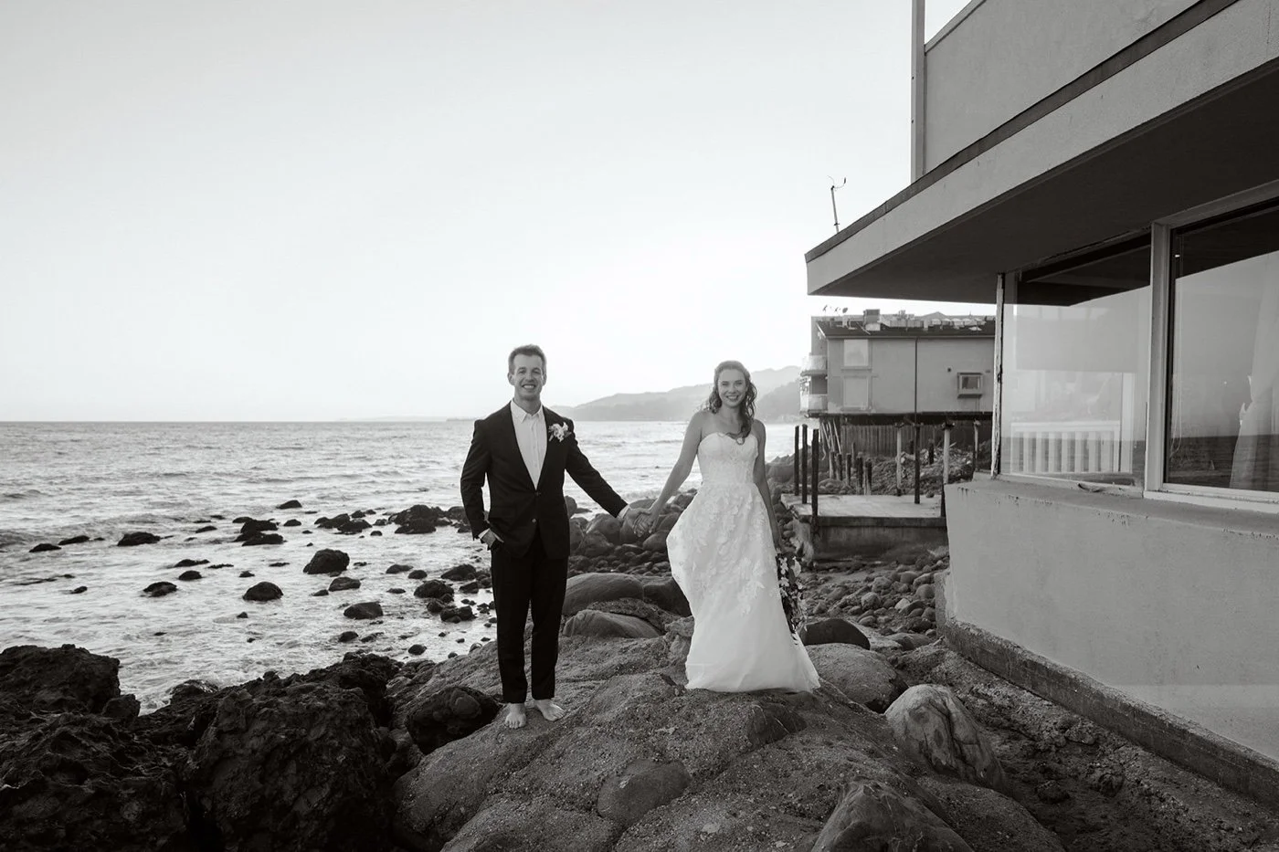Bride and groom at Duke's Malibu in front of the ocean