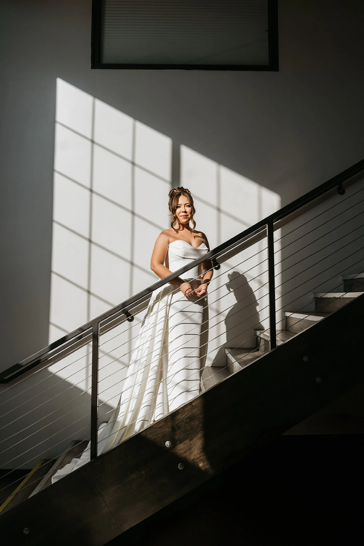 Bride on steps at Hangar 21 with shadow