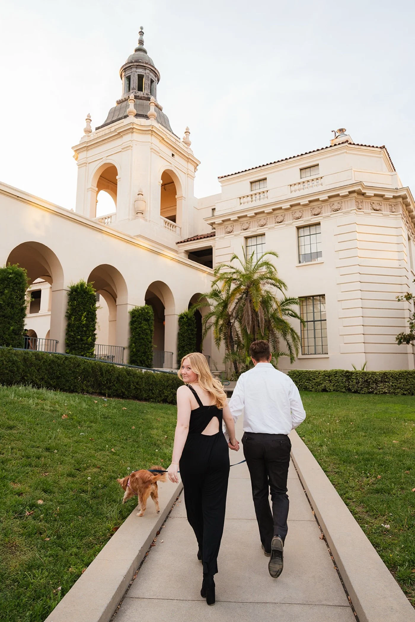 Couple walking hand in hand at Pasadena City Hall