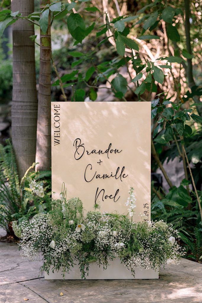 a wedding sign for brandon and camille noel's wedding at hartley botanica in somis