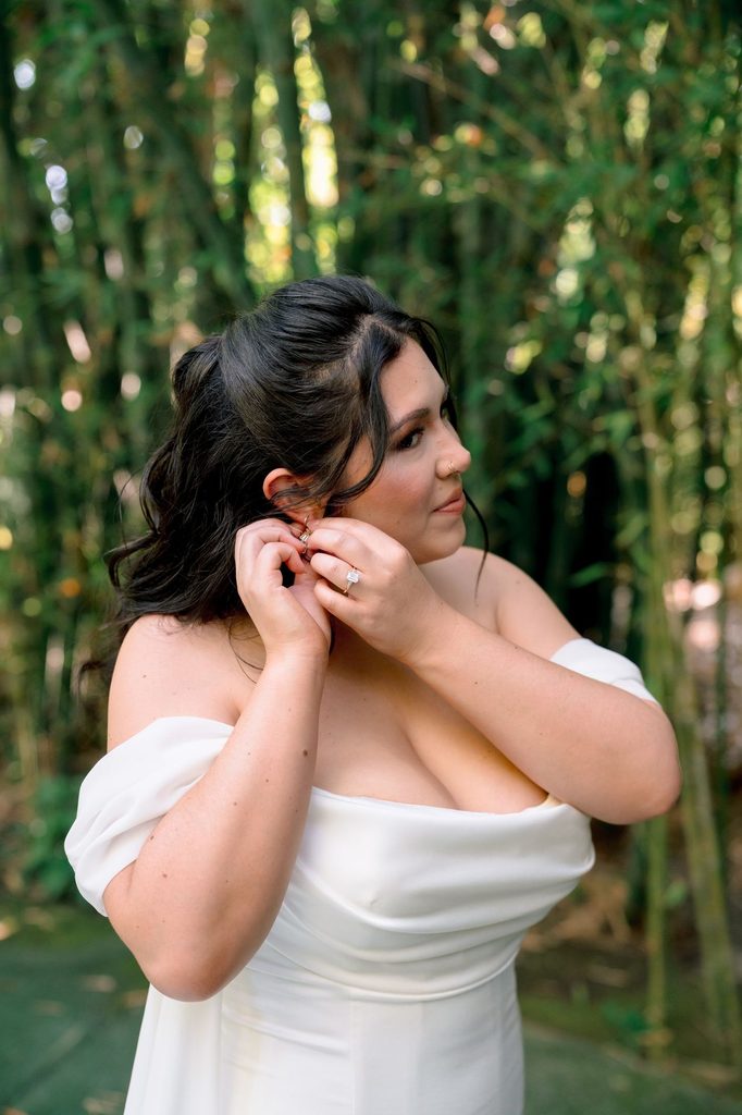 Bride putting in her earrings before the ceremony