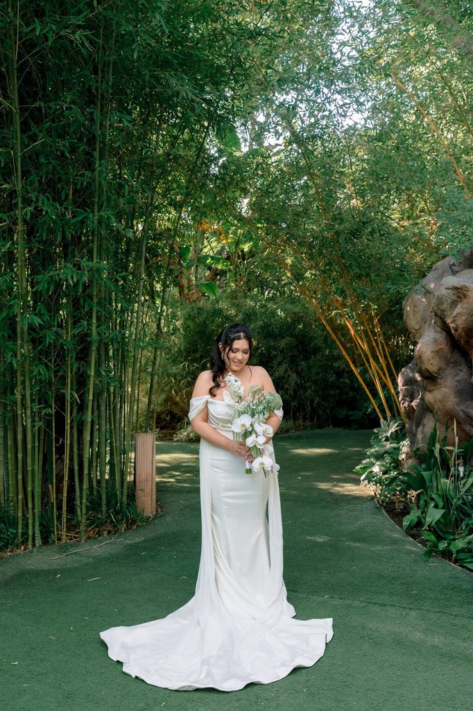 Bride with her bouquet on the bamboo path at Hartley Botanica in Somis