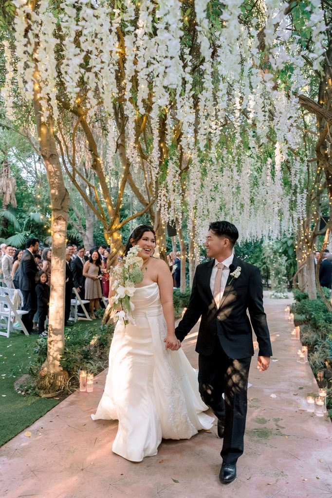 Recessional through the hanging-flower aisle at Hartley Botanica