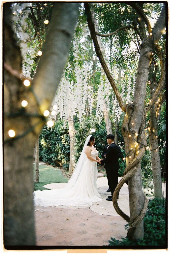 Bride and groom beneath the trees after the ceremony, on film