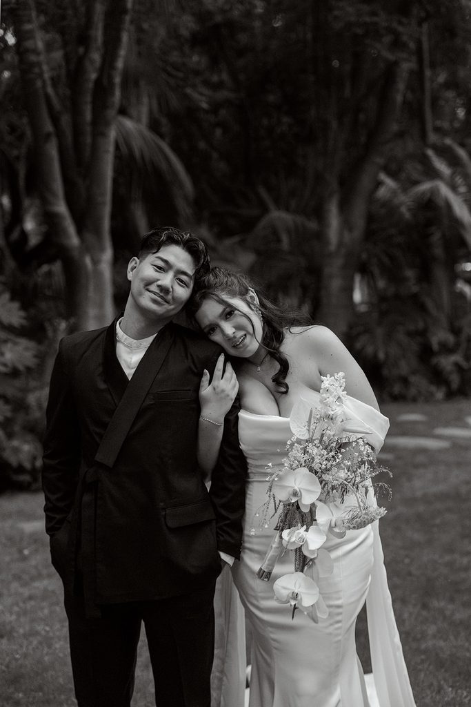 Bride and groom laughing together, black and white