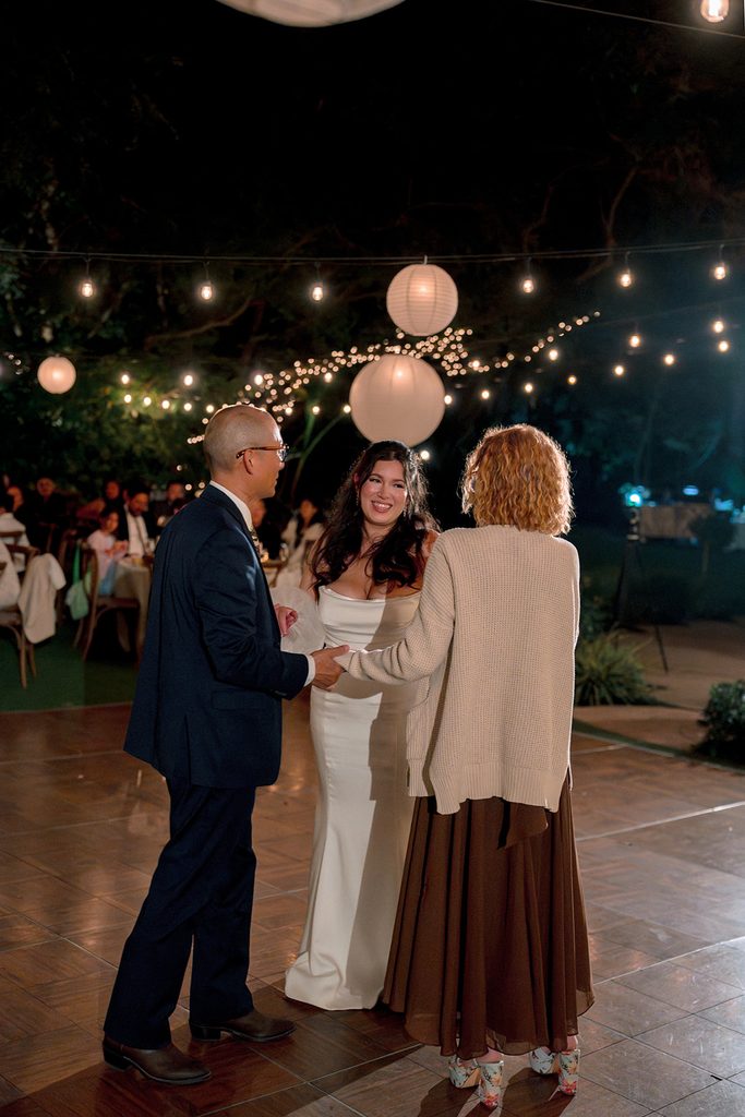 Bride dancing with her parents at the reception